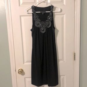 Black dress with statement neck beaded detail. 10.